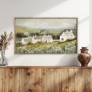 May include: A painting depicting a row of white houses with green roofs set against a rural landscape. The houses are surrounded by green fields and trees, with white flowers in the foreground.