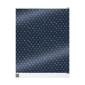 May include: A rectangular sheet with a dark blue background covered in small, white star shapes. A lighter blue, curved stripe runs diagonally across the sheet. The bottom edge has a white border.