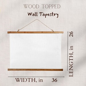 May include: A wood-topped wall tapestry, 36 inches wide and 26 inches long, hangs from a natural rope. The white fabric is held by wooden rods at the top and bottom. The words "WOOD TOPPED" and "Wall Tapestry" are printed at the top.