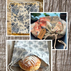 May include: Three fabric drawstring bags for bread storage labeled Standard Sourdough and 13 inches by 14 inches. One bag features a blue floral print, another a multi-colored floral pattern with a brown tag, and one a grey tree print holding a loaf of bread.