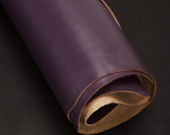 May include: A roll of dark purple leather with a light brown edge. The leather is rolled up tightly and the edge is visible.