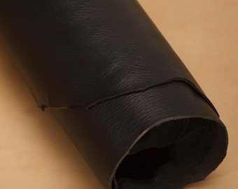 May include: A roll of black leather, showing the texture and grain of the material.