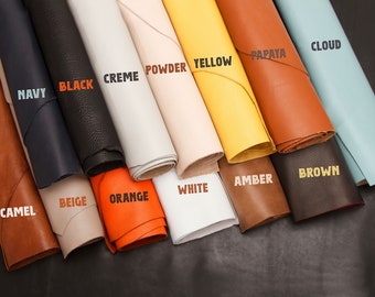May include: A variety of leather swatches in different colors, including camel, beige, orange, white, amber, brown, papaya, cloud, yellow, powder, creme, black, and navy.