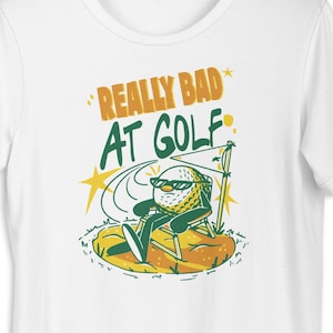Zabawna koszulka z złym golfistą: Zabawna koszulka z grafiką piłki golfowej