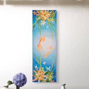 May include: Vertical canvas art featuring two orange goldfish swimming in a blue aquatic scene. The painting includes orange and white flowers, green stems, and small white flowers. The artwork has a bright, airy feel.