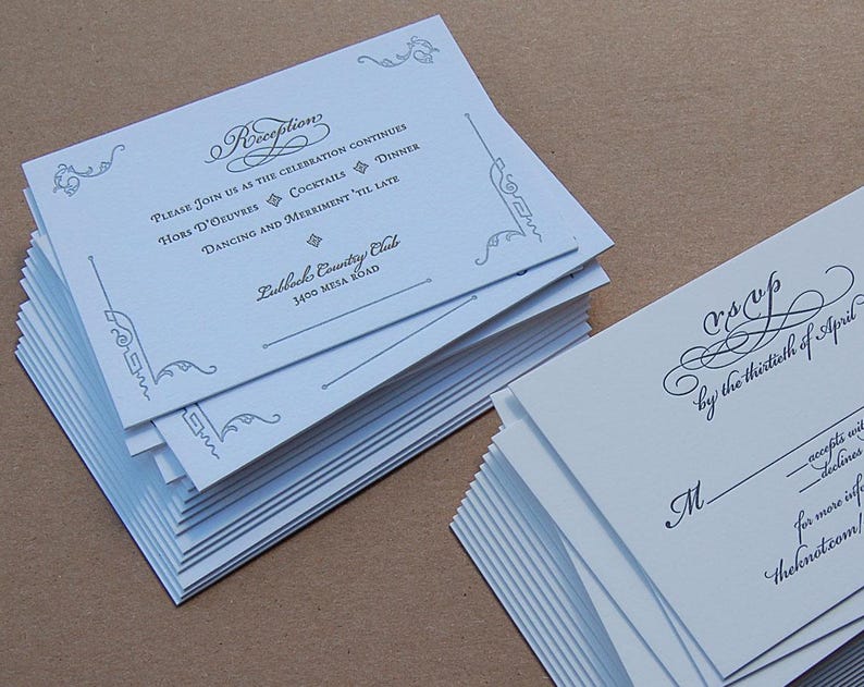 May include: Stacks of white wedding reception invitations and RSVP cards. The invitations have elegant script and decorative flourishes. The reception card includes details like "Hors D'oeuvres" and "Dancing and Merriment". The RSVP cards have a space for the recipient's name.