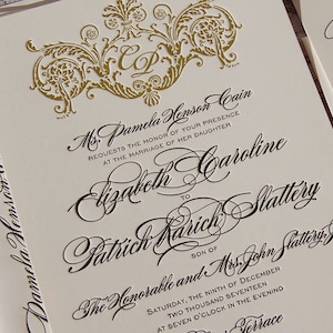 May include: A formal wedding invitation with gold embossed details. The invitation reads "Ms. Pamela Henson Cain requests the honor of your presence at the marriage of her daughter Elizabeth Caroline to Patrick Karich Slattery son of The Honorable and Mrs. John Slattery. Saturday, the ninth of December two thousand seventeen at seven o'clock in the evening Terrace."