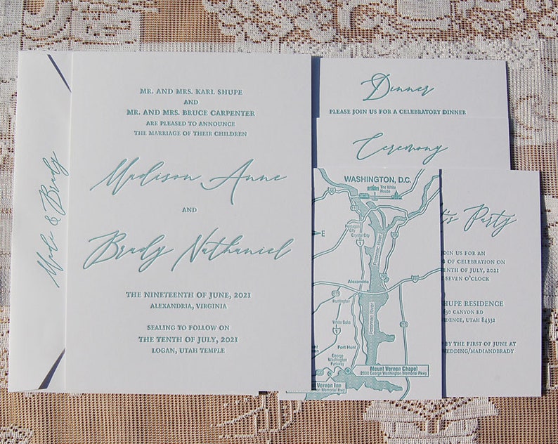 May include: Wedding invitation suite with a light teal script font on white cardstock. The suite includes an invitation, dinner and ceremony cards, and a map. The invitation reads "Madison Anne and Brady Nathaniel".