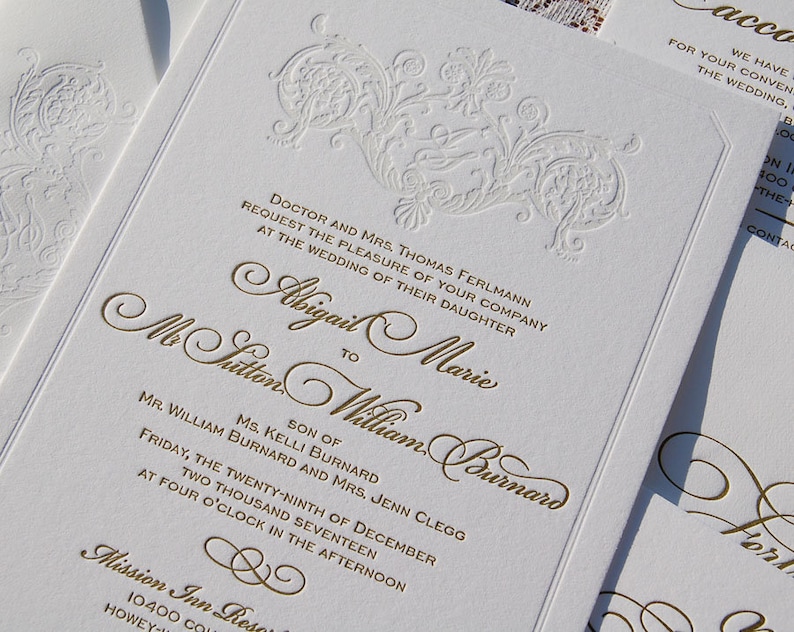 May include: Elegant white wedding invitations with gold embossed text and floral designs. The invitation includes the names Abigail Marie and Mr. Sutton William Burnard, along with the wedding date and time. The invitations are for the wedding of the daughter of Doctor and Mrs. Thomas Ferlmann.