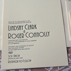May include: Ivory wedding invitation with black text. The invitation includes the names "Lindsay Clark & Roger Connolly", wedding details, and the address "501 Union, Brooklyn, New York". The invitation is part of a set.