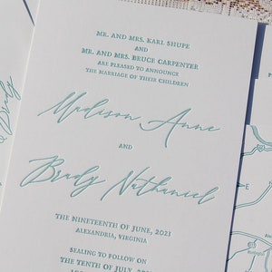 May include: White wedding invitation with teal script. The invitation announces the marriage of Madison Anne and Brady Nathaniel, with the date and location in Alexandria, Virginia. The invitation also includes a map.
