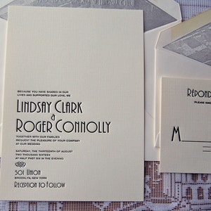 May include: Cream-colored wedding invitation suite with black text. The main invitation features the names "Lindsay Clark & Roger Connolly" and wedding details. Includes a response card and envelopes.