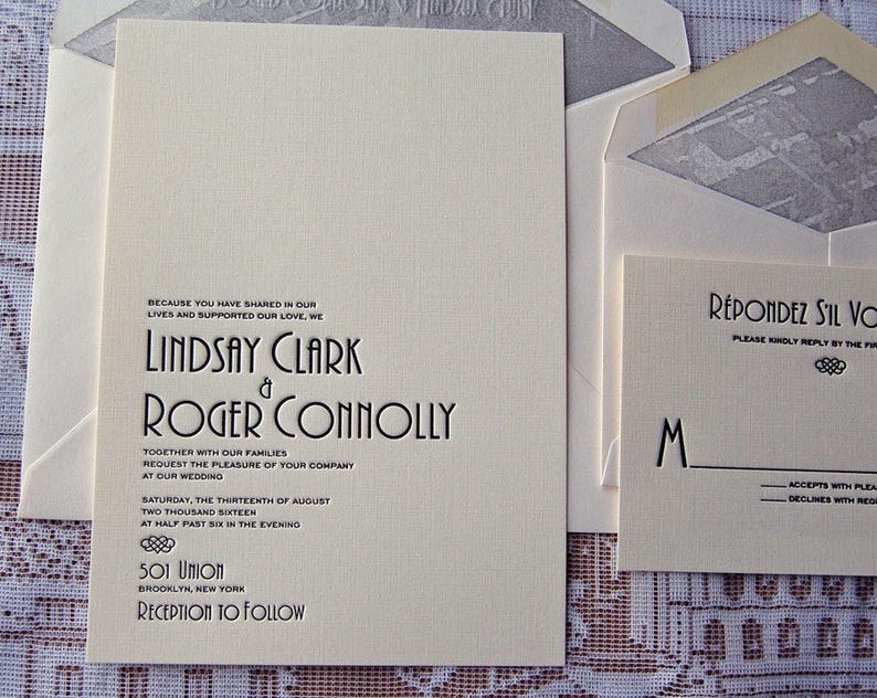 May include: Cream-colored wedding invitation suite with black text. The main invitation features the names "Lindsay Clark & Roger Connolly" and wedding details. Includes a response card and envelopes.