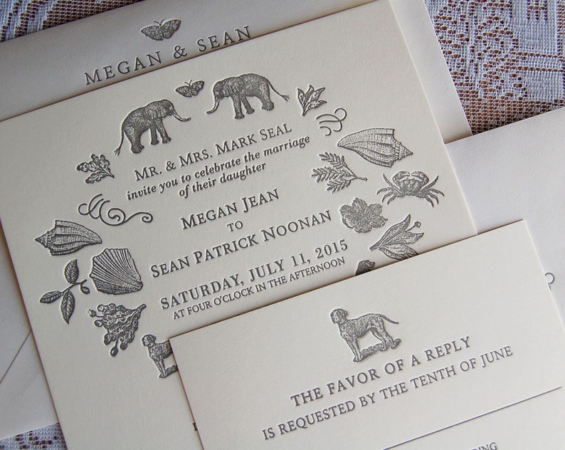 May include: Ivory wedding invitation suite with gray illustrations of elephants, butterflies, leaves, and shells. The invitation includes the names Megan and Sean, and the date July 11, 2015. A smaller card requests a reply by the tenth of June.