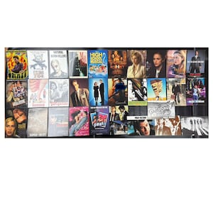 May include: A collection of movie DVDs, featuring titles like "Pulp Fiction," "Romeo + Juliet," and "Natural Born Killers." The covers display various actors and movie scenes, with a range of colors and designs. The DVDs are arranged in a grid.
