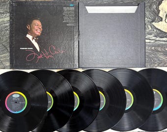 May include: A vintage vinyl record album set featuring a black album cover with a portrait of Nat King Cole and the title "Forever Yours." The set includes several black vinyl records with colorful labels, and a black album sleeve.