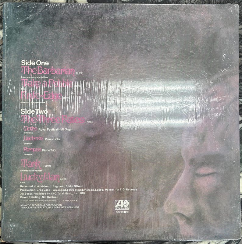 May include: A vinyl record album cover with song titles including "The Barbarian" and "Lucky Man." The cover displays a profile of a person's face and the Atlantic Records logo. The album is in a plastic sleeve.