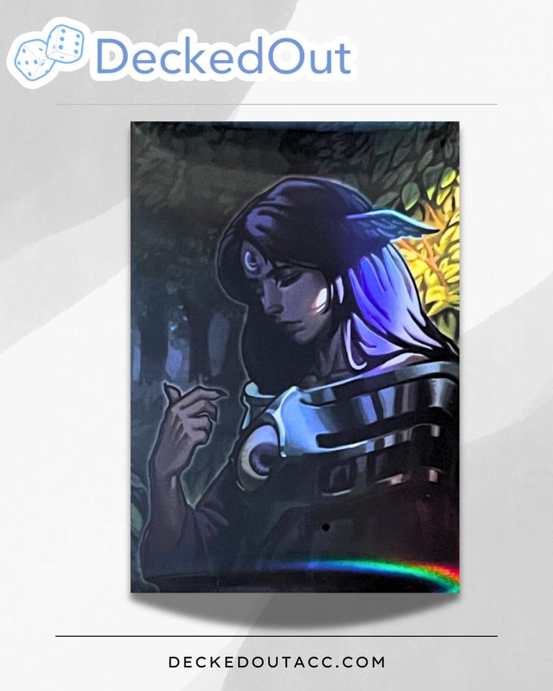 May include: A holographic card featuring a woman with long blue hair and a crescent moon on her forehead. She is wearing a dark robe with silver accents and a feathered headdress. The background is a dark forest with a hint of yellow light.
