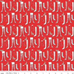 May include: Red fabric with a repeating pattern of white and red striped stockings, red and white striped socks, and blue socks with white stripes. The socks are arranged in a random pattern.