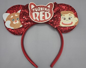 May include: Red sequined headband with large round ears featuring characters from the movie "Turning Red." The center of the headband has the words "Turning Red" in a red glittery design. The ears have character images.