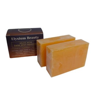 Può includere: Due saponette arancioni con il testo "Elysium Beauty Kojic Acid Dark Spot Remover Vitamin C Turmeric Collagen Natural Soap Bars with Turmeric Original Japanese Complex for Dark Spots Correction" sulla confezione.