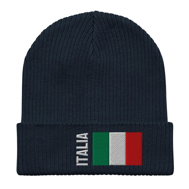 May include: A navy blue knitted beanie with a white "ITALIA" text and the Italian flag embroidered on the front.