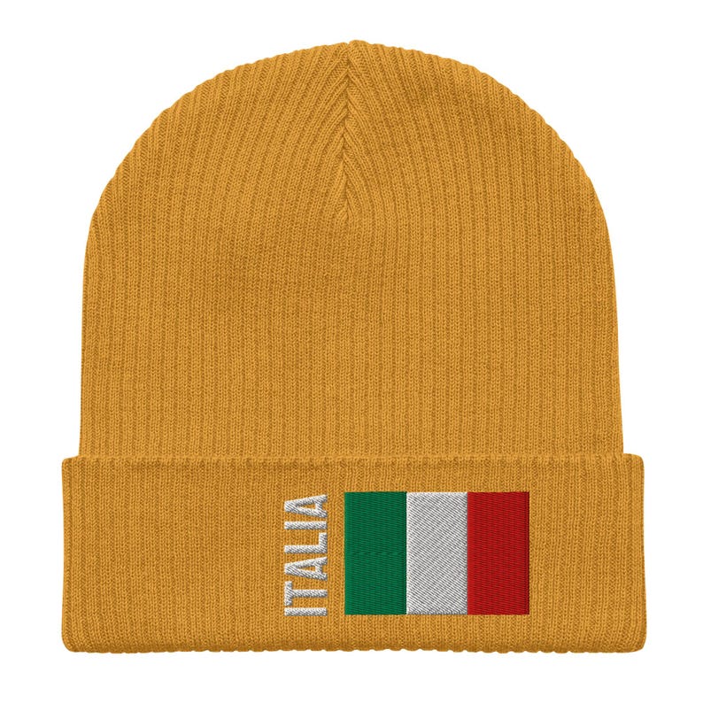 May include: A mustard yellow knit beanie with a white embroidered Italian flag and the word "ITALIA" on the front.