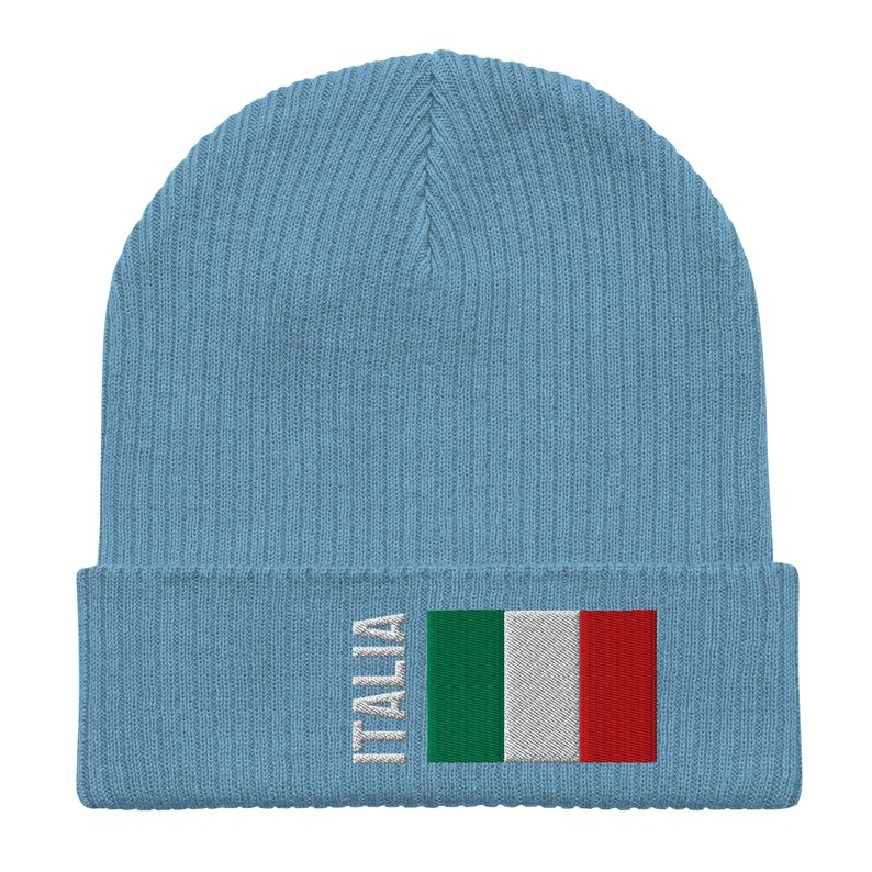 May include: A light blue knitted beanie with the word "ITALIA" and the Italian flag embroidered on the front.