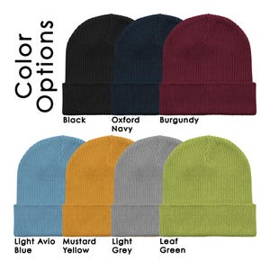 May include: Assortment of ten knit beanies in various colors, including black, navy, burgundy, light blue, mustard yellow, light grey, and leaf green.