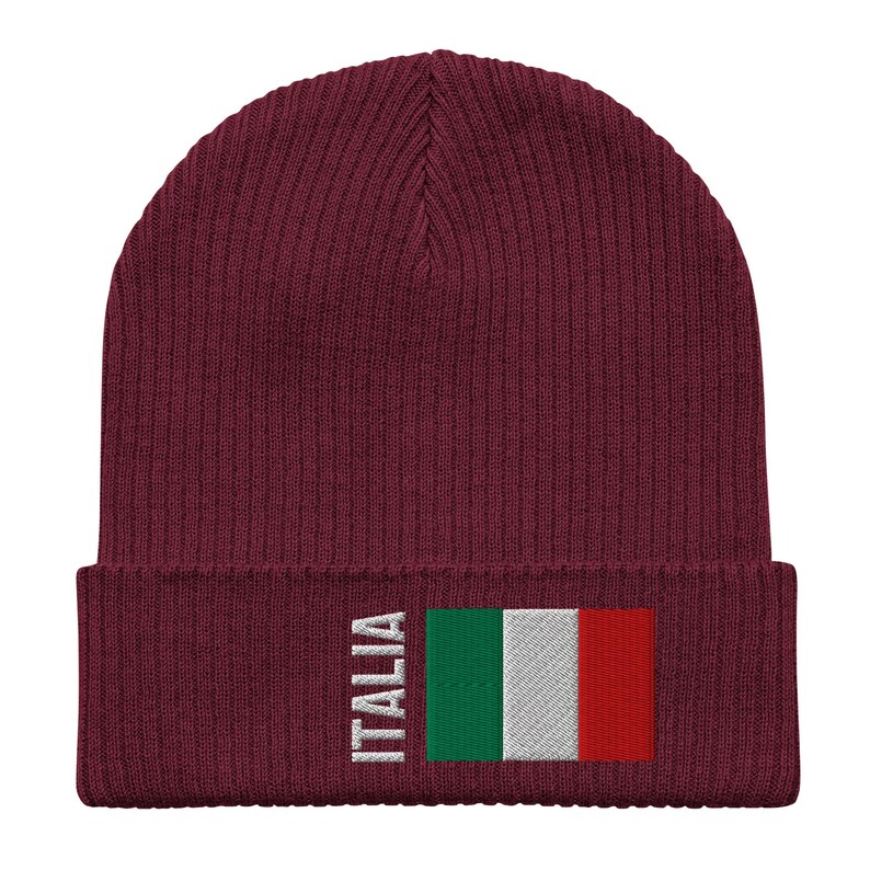 May include: A maroon knitted beanie with a white embroidered Italian flag and the word "ITALIA" on the front.