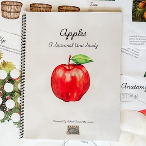 May include: A colorful book cover with the title "Apples: A Seasonal Unit Study" and a red apple illustration. The book is presented by School Around the Corner.