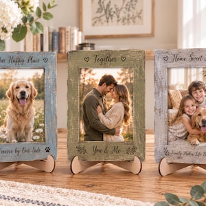 May include: Three rectangular wooden picture frames with distressed finishes in blue, green, and grey. Each frame features engraved text and icons: Our Happy Place, Together, and Home Sweet Home. The frames are supported by small wooden stands.