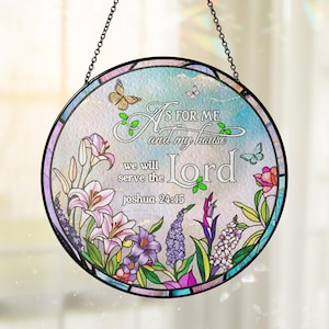 May include: A round stained glass window hanging with a black metal frame and chain. The window features the text "As for me and my house, we will serve the Lord, Joshua 24:15." Floral and butterfly designs in pink, purple, and blue decorate the glass.