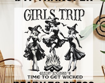 May include: A white t-shirt with a black and white illustration of three witches dancing around a bonfire. The text "Girls Trip" is above the witches and the text "Time to Get Wicked" is below the witches. The text "42.5197° N.70.8955° W" is in between the two lines of text. The text "Ready to Press" is at the bottom of the shirt.