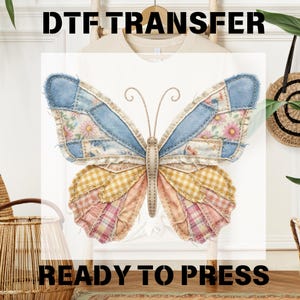May include: A white t-shirt with a large butterfly design. The butterfly is made of patchwork denim, floral, and gingham fabrics in shades of blue, yellow, and pink. The text "DTF TRANSFER READY TO PRESS" is printed above and below the butterfly.