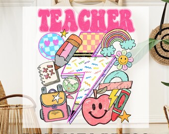 May include: A pink and white iron-on transfer design with the word "TEACHER" in a retro font. The design includes a rainbow, a pencil, a globe, a backpack, a ruler, a crayon, a star, a smiley face apple, and a smiley face flower.