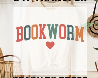 May include: White long-sleeve t-shirt with a colorful "BOOKWORM" graphic and a red heart. The shirt is ready to press with a DTF transfer.
