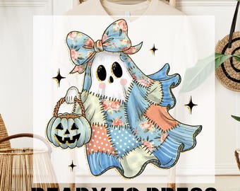 May include: A white DTF transfer featuring a cartoon ghost with a patchwork quilt design. The ghost is holding a pumpkin basket and wearing a floral bow. The text "DTF TRANSFER" and "READY TO PRESS" are at the top and bottom.