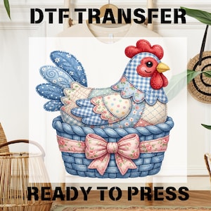 May include: A colourful DTF transfer design featuring a patchwork hen in a blue basket with a pink floral bow. The hen has blue and floral patterned wings and a red comb. Text at the top reads "DTF TRANSFER" and at the bottom "READY TO PRESS".