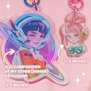 Overwatch mini keychains featuring Pink Mercy, Dokiwatch Juno, Rainy Day Kiriko, and Rainy Day Mei. Each is 1.5 inches with double-sided glitter epoxy and a broken glass holographic effect on one side. Cute Overwatch gift for support mains, gamer girls, and fans of OW2 skins and collectibles. Great for bags, backpacks, and keys. Handmade fanmade merchandise for Overwatch lovers and kawaii gaming aesthetic. Painted and produced by Chryssv.