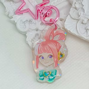 Overwatch mini keychains featuring Pink Mercy, Dokiwatch Juno, Rainy Day Kiriko, and Rainy Day Mei. Each is 1.5 inches with double-sided glitter epoxy and a broken glass holographic effect on one side. Cute Overwatch gift for support mains, gamer girls, and fans of OW2 skins and collectibles. Great for bags, backpacks, and keys. Handmade fanmade merchandise for Overwatch lovers and kawaii gaming aesthetic. Painted and produced by Chryssv.