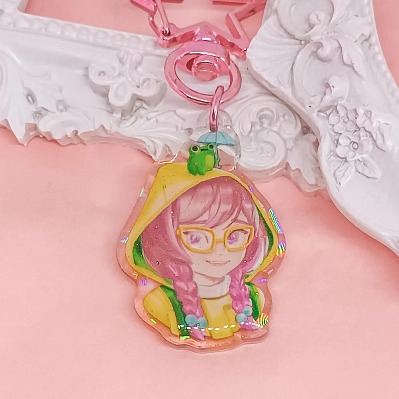 Overwatch mini keychains featuring Pink Mercy, Dokiwatch Juno, Rainy Day Kiriko, and Rainy Day Mei. Each is 1.5 inches with double-sided glitter epoxy and a broken glass holographic effect on one side. Cute Overwatch gift for support mains, gamer girls, and fans of OW2 skins and collectibles. Great for bags, backpacks, and keys. Handmade fanmade merchandise for Overwatch lovers and kawaii gaming aesthetic. Painted and produced by Chryssv.