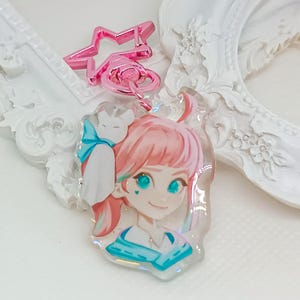 Overwatch mini keychains featuring Pink Mercy, Dokiwatch Juno, Rainy Day Kiriko, and Rainy Day Mei. Each is 1.5 inches with double-sided glitter epoxy and a broken glass holographic effect on one side. Cute Overwatch gift for support mains, gamer girls, and fans of OW2 skins and collectibles. Great for bags, backpacks, and keys. Handmade fanmade merchandise for Overwatch lovers and kawaii gaming aesthetic. Painted and produced by Chryssv.