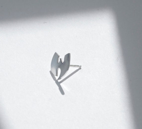 A stud to remember, Wu-Tang is forever. One small sterling silver handmade, one of a kind, hand sawed Wu-Tang Clan stud earring