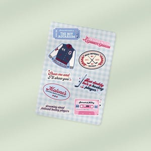 May include: A sheet of stickers with a light blue and white checkered pattern. The stickers feature various designs, including a varsity jacket, hockey-themed graphics, and text such as "Show me and I'll show you." and "Hot daddy is a hockey player."