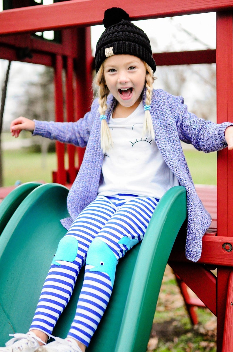 Kids royal blue and white stripe cotton lycra leggings with light blue whale appliqués on the knees. In sizes 2T to 10 years old.