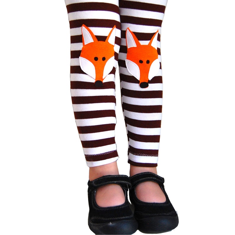 Kids brown and white striped cotton lycra leggings with orange fox face knee patches designed by me. Available in sizes 2T to 10 years old