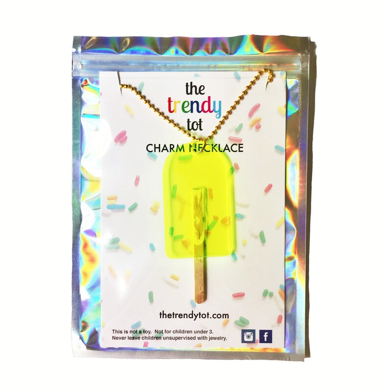 Neon yellow translucent popsicle with no bite and real wooden popsicle stick in creative iridescent freeze-dried ice cream packaging. 24 inches long. Great for kids or adults.