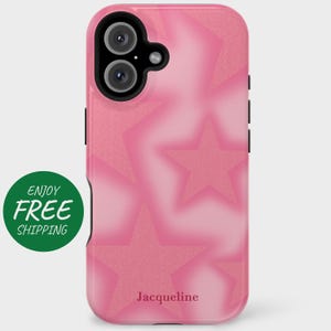 May include: Pink phone case with a star pattern and the name "Jacqueline" at the bottom. The case has a glossy finish and a black camera cutout. The stars are a darker shade of pink and have a glittery texture.