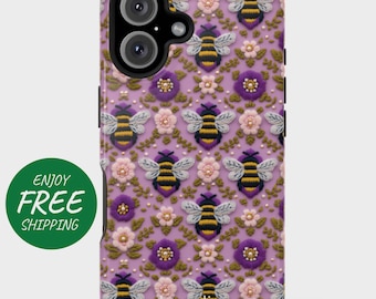 May include: A lavender phone case featuring a repeating pattern of embroidered bees, flowers, and leaves. The bees have yellow and black stripes, with white wings. The flowers are pink and purple. The case has a black camera lens and the name "Jacqueline" at the bottom.